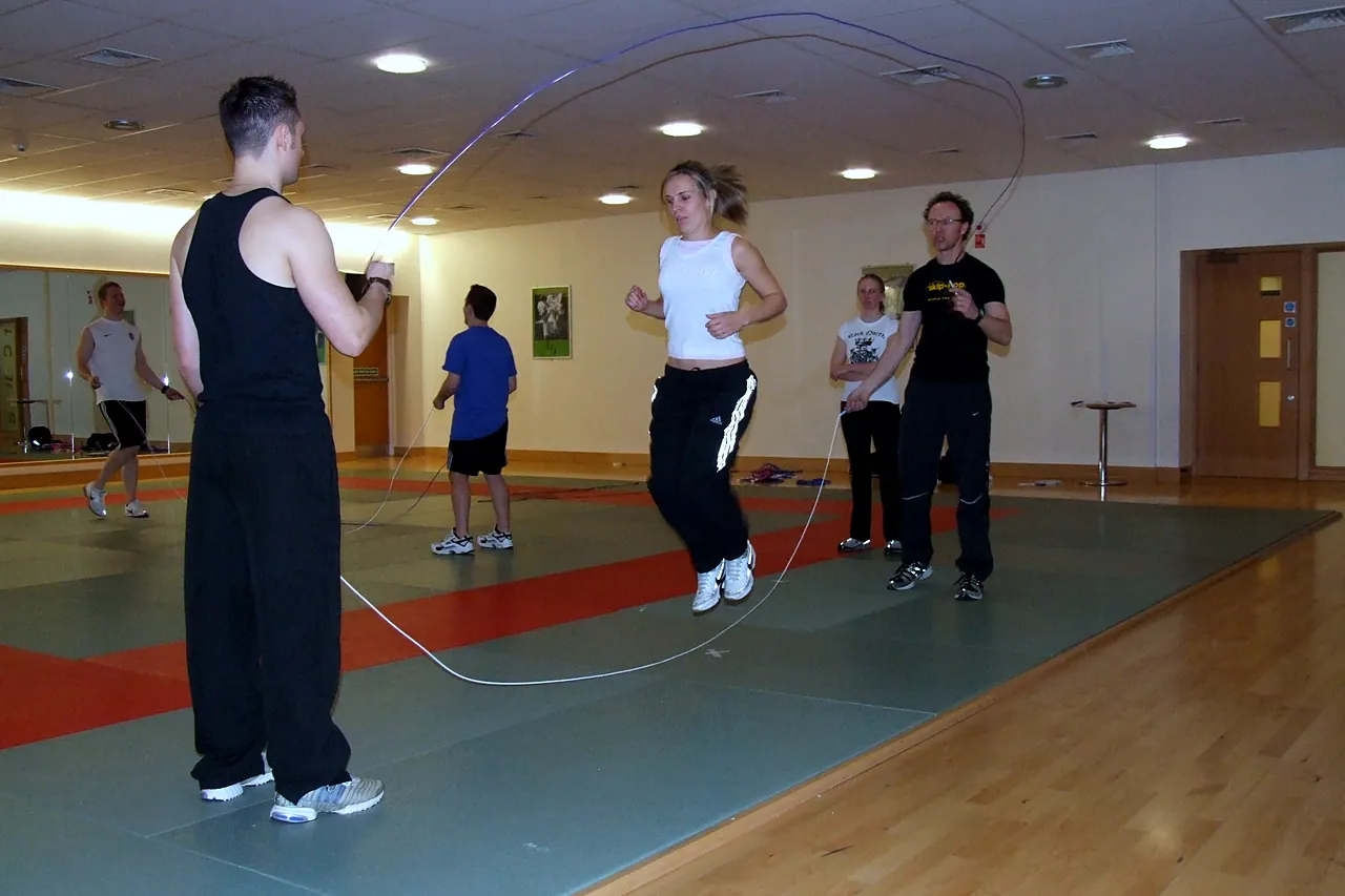 Teachers take turns jumping a long rope on a skip-hop skipping training day