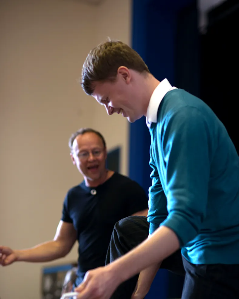 Lee Collinson-James laughs with a teacher learning a new skill