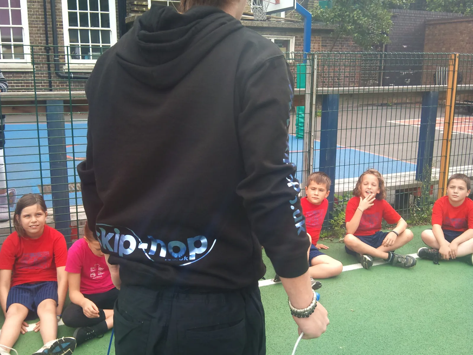 A skip-hop coach teaching skipping to a primary school class